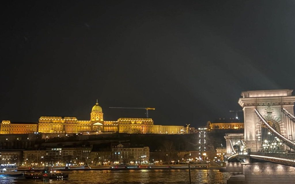 Illuminated Chain Bridge and Buda Castle across the Danube at night in Budapest