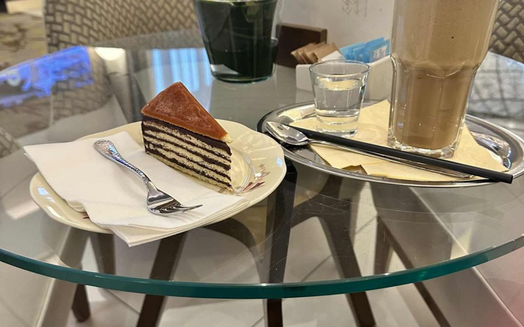 Layered Hungarian cake and coffee served at a Budapest café