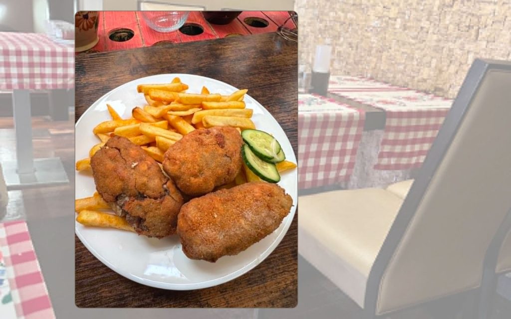 Breaded fried marrow served with chips in Budapest